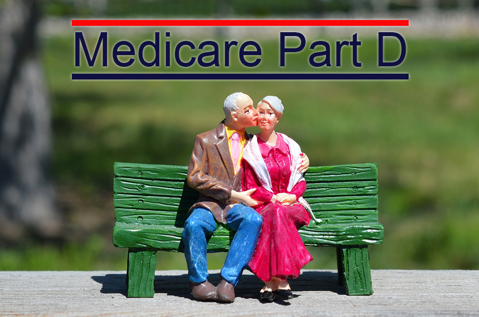 Elderly-Couple-On-Park-Bench-Under-Medicare-Part-D-Sign