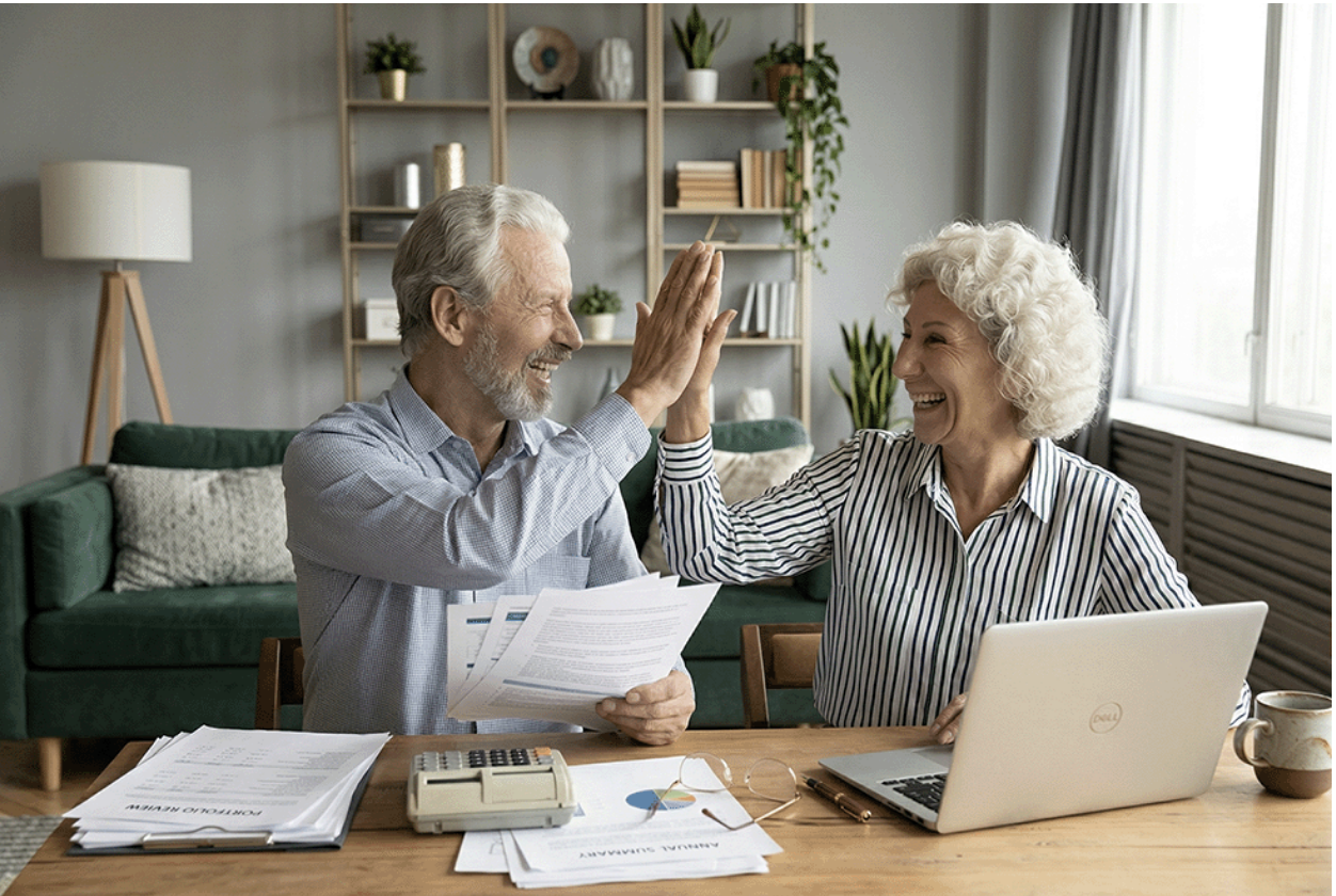 A couple celebrating after seeing the amount of Medicare premium tax deductions they will get for 2026.