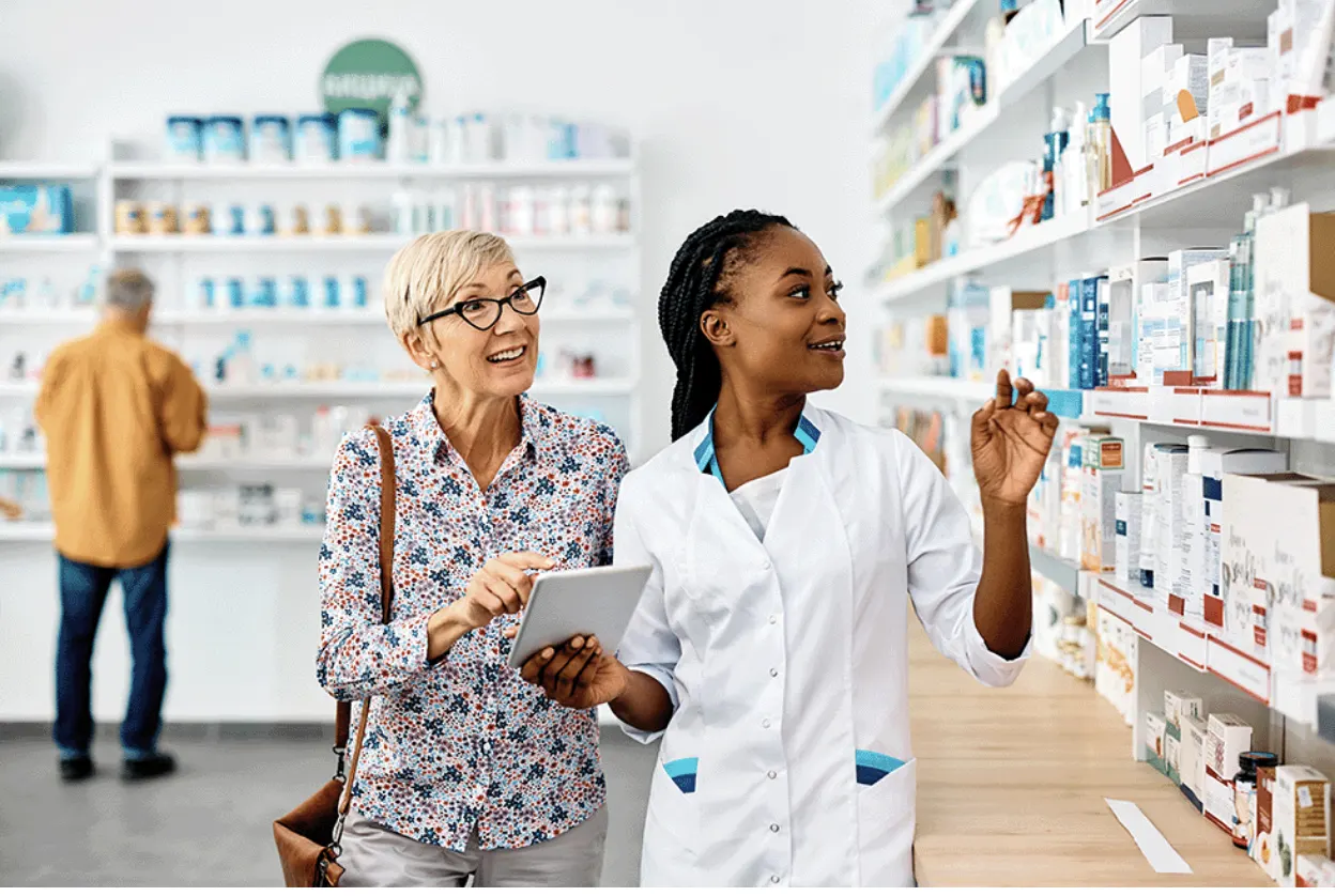 A woman and her pharmacist browsing the counter for medication.
