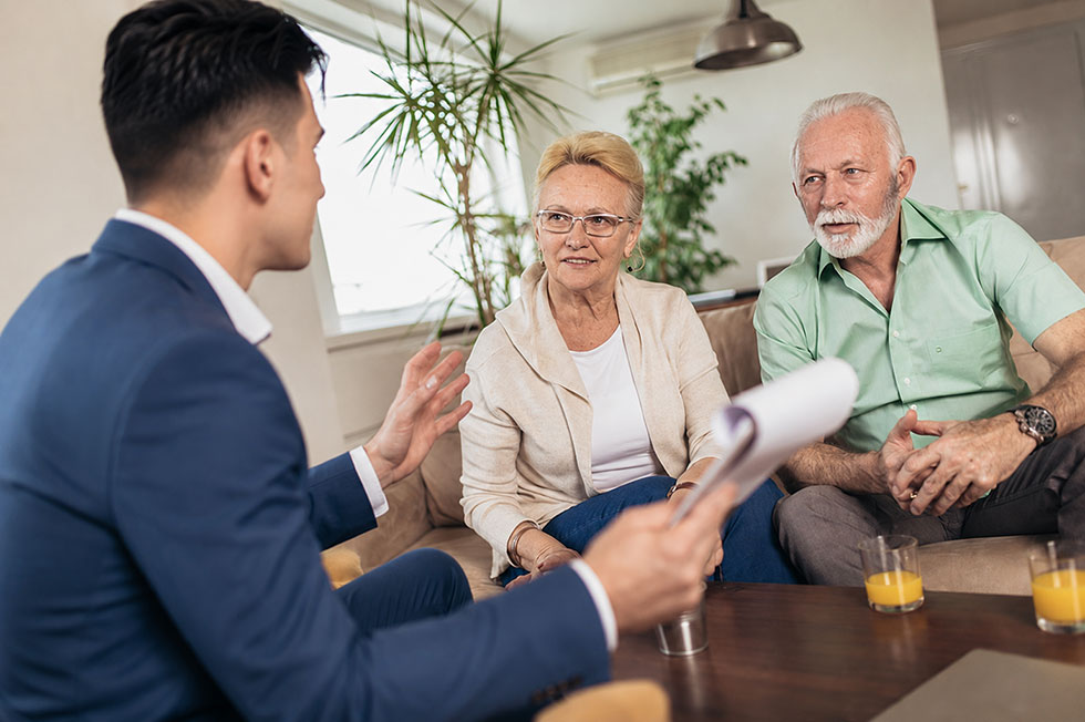 An Absolute Best Insurance agent explains Medigap options with a senior couple in their Greenacres home.